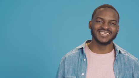 Smiling-african-american-fun-and-happy-black-man-looking-at-camera.